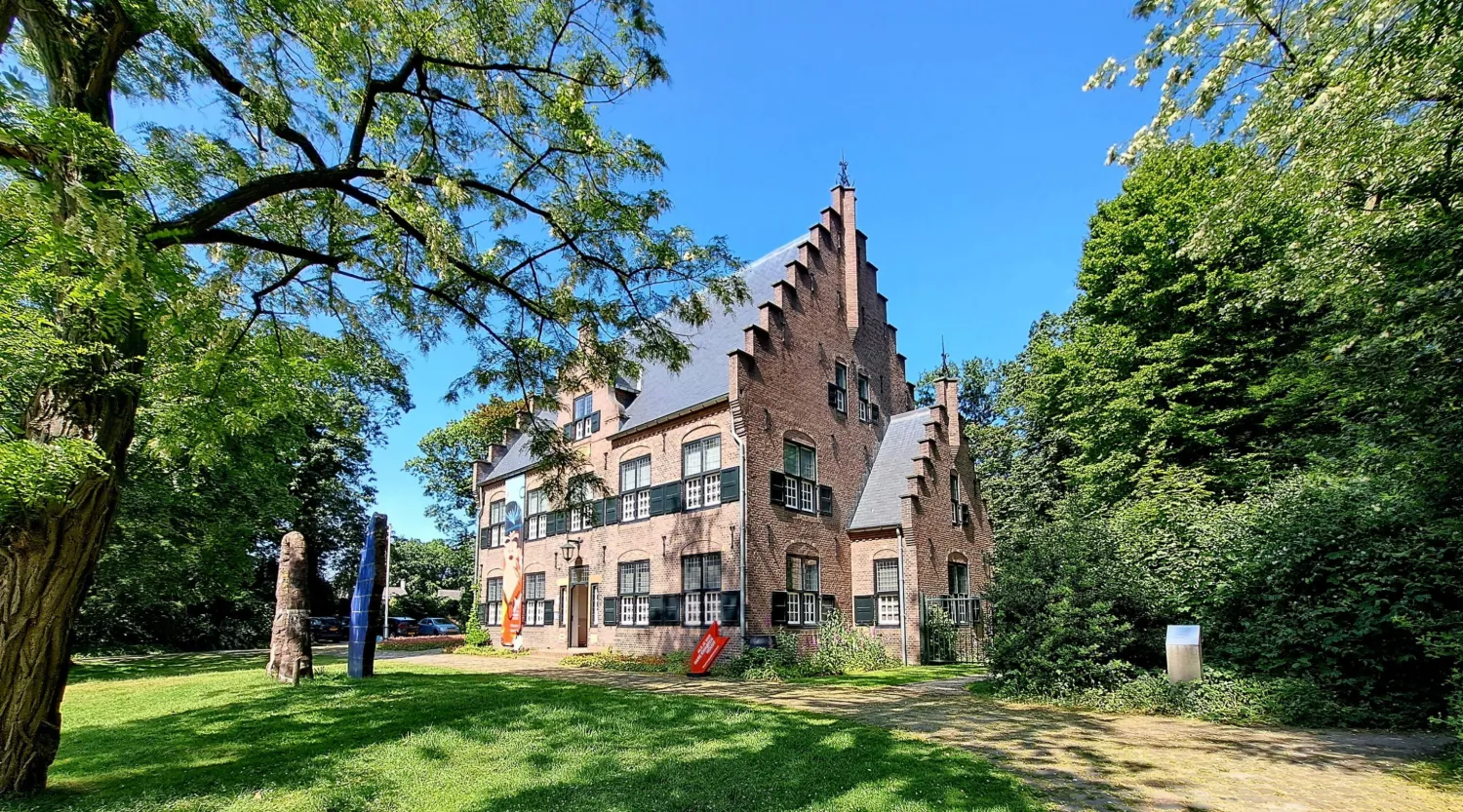 Museum De Wieger in Deurne, het voormalige woonhuis van Hendrik Wiegersma met trapgevels, omringd door groen